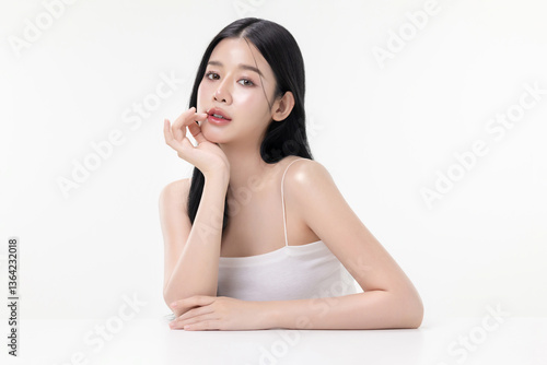Portrait beautiful young Asian woman with K beauty style makeup and perfect skin on isolated white background. Facial and skin care concept for commercial advertising.