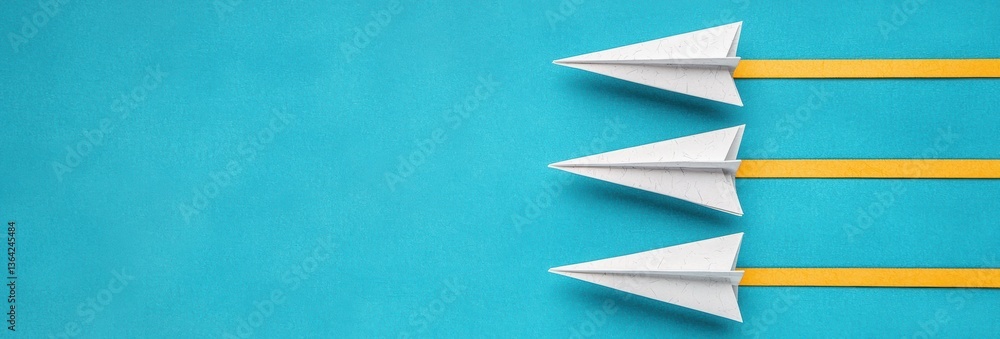 Three Paper Airplanes with Yellow Tails on a Vibrant Turquoise Background Three Paper Airplanes with Yellow Tails on a Vibrant Turquoise Background