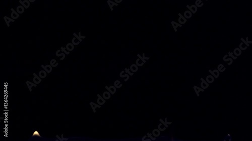 Flames are burning isolated on a black background. Concept of particles, sparkles, flame and light.
