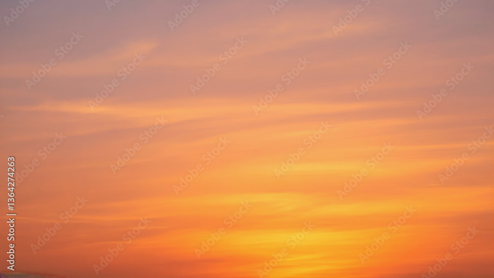 Obraz premium Vibrant Sky: A canvas of radiant colors unfolds across the expanse, with hues of orange, pink, and purple merging in a breathtaking sunset display. 