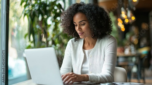 A confident female tax consultant reviewing an e-invoice on her laptop