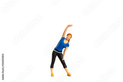A figurine of a woman in workout attire performing a side stretch isolated on white background with clipping path