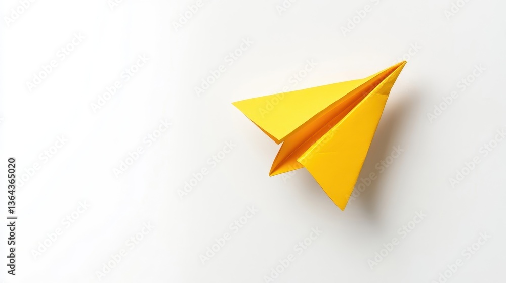 A vibrant yellow paper airplane on a plain white surface A vibrant yellow paper airplane on a plain white surface