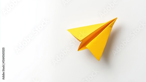 Wallpaper Mural A vibrant yellow paper airplane on a plain white surface Torontodigital.ca