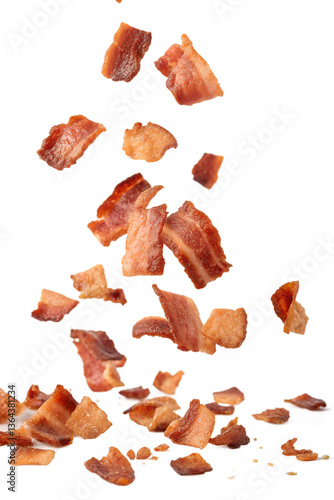 Bacon bits cut into pieces float in the air isolated on a transparent background