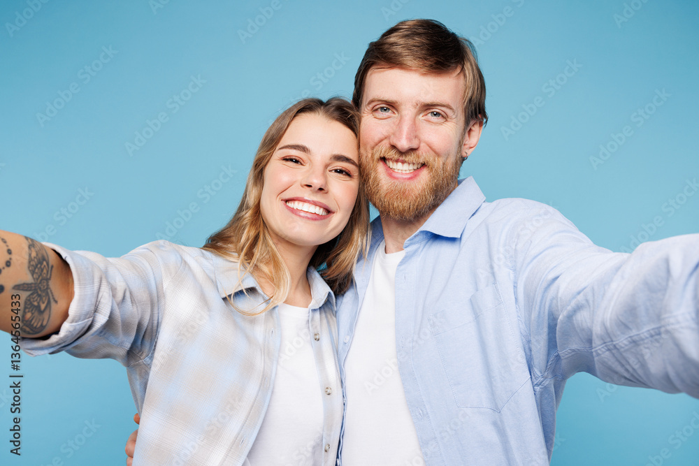 Close up young couple two friends family man woman wear shirt casual clothes together doing selfie shot pov on mobile cell phone isolated on pastel plain blue cyan background studio Lifestyle concept Close up young couple two friends family man woman wear shirt casual clothes together doing selfie shot pov on mobile cell phone isolated on pastel plain blue cyan background studio Lifestyle concept
