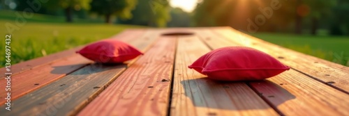Low angle view of corn hole game with red bean bags on wooden platform, red bags, casual games