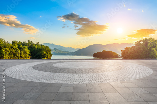 Fototapeta Naklejka Na Ścianę i Meble -  Empty square floor and lake with mountain scenery at sunset