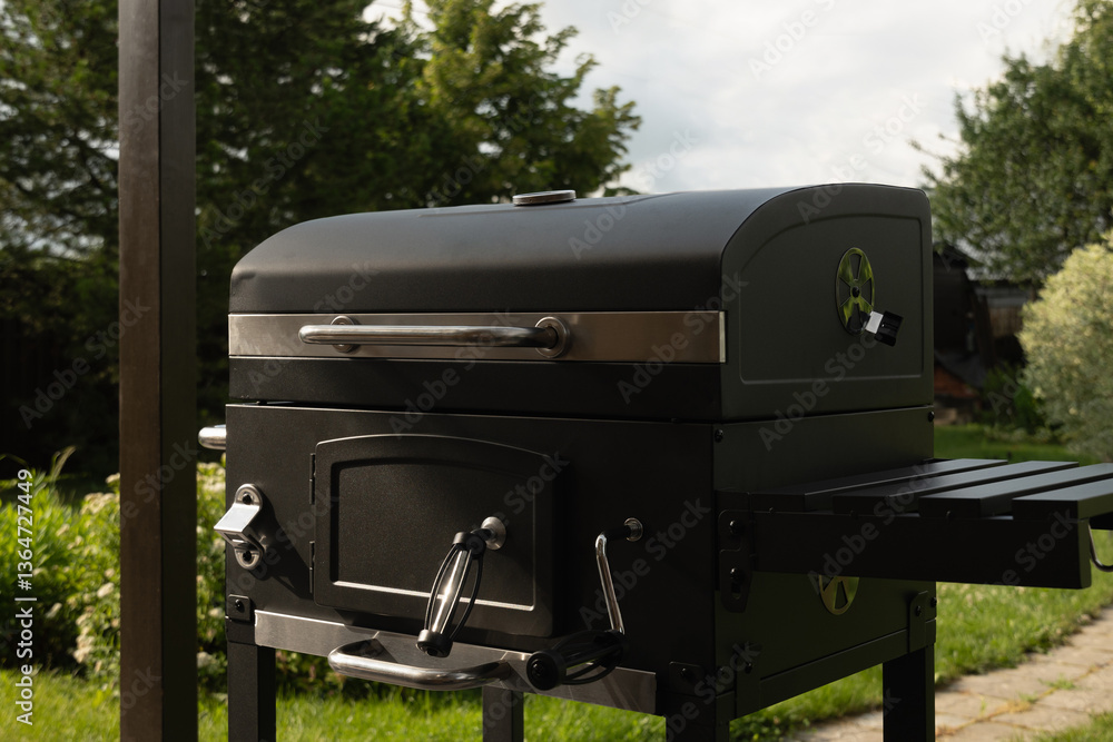 New portable charcoal barbecue grill for summer party at patio. Summer. Outdoors. BBQ grill.