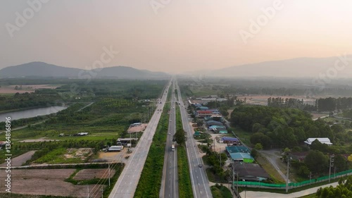 Aerial View of Highway Through Green Landscapes and Mountains Scenic Journey of Nature and Transportation on Open Road