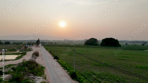 Tranquil Sunset Landscape Serene Evening Over Agricultural Fields and Winding Roads, Embracing Natures Beauty on Rural Horizon