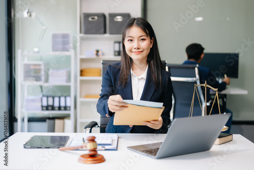 Asian woman lawyer working and gavel, tablet, laptop in front, Advice justice and law concept..