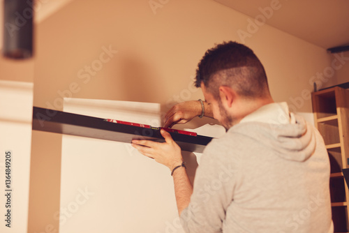 Obraz na płótnie Handyman mounting and fixing kitchen cabinets and shelf. w salonie