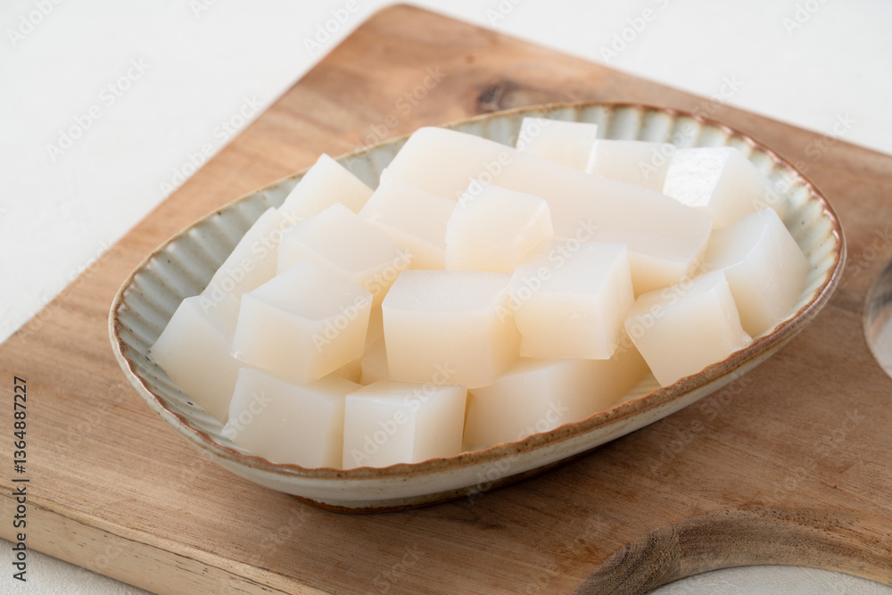 Raw konjac in square shape, also named konnyaku in Japan. Raw konjac in square shape, also named konnyaku in Japan.