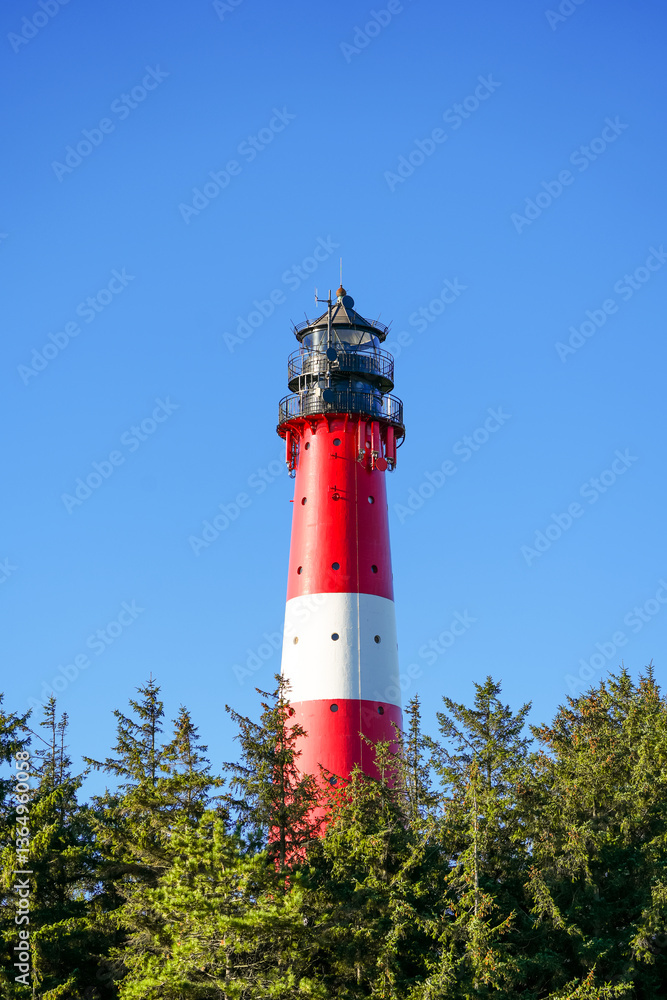 View of the red and white Hörnum lighthouse in the south of the island of Sylt.
View of the red and white Hörnum lighthouse in the south of the island of Sylt.