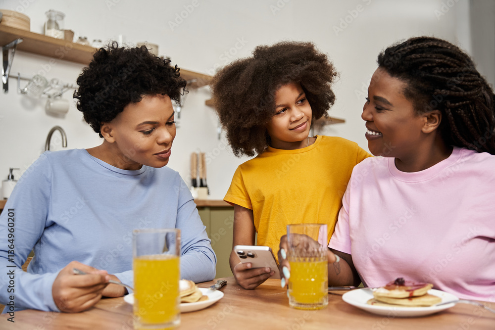 Family bonding over breakfast while sharing smiles and laughter at home together Family bonding over breakfast while sharing smiles and laughter at home together