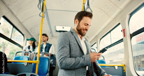 Obraz na płótnie Business, man and journey on bus with phone for travel schedule, checking notifications and morning commute. Happy, passenger and smartphone on public transport for work destination and social media w salonie