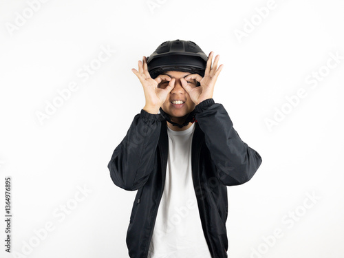 Young Asian man wearing motorbike helmet giving 