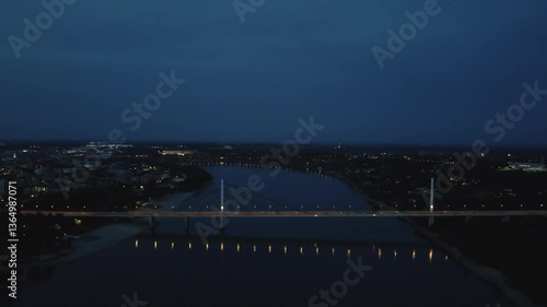 City skyline at night with illuminated bridge and river view showcasing urban tranquility