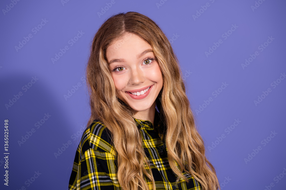 Fototapeta premium Smiling young woman in checkered shirt against purple background, conveying positive and stylish vibe