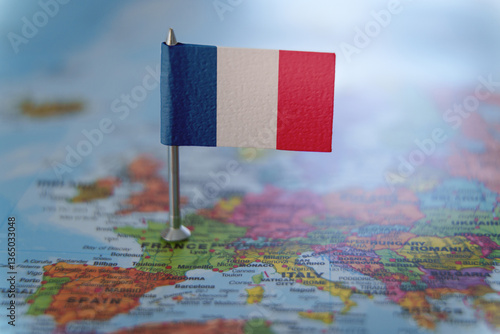 France map with a pin showing the national flag. Close-up view. Travel, geography, and politics concept