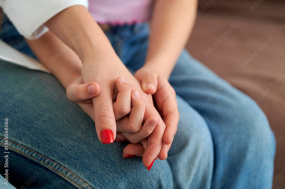 Hands Holding Together in a Moment of Connection on a Couch Hands Holding Together in a Moment of Connection on a Couch