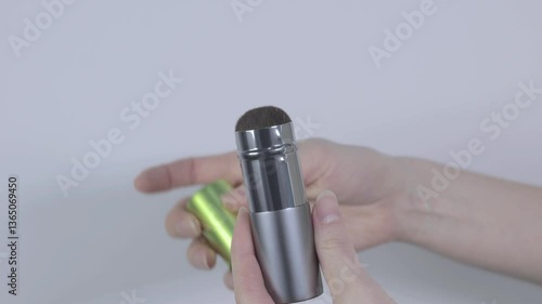 Woman closing retractable face brush for powder or blush. Beauty and make up concept. Close up, 4k footage.