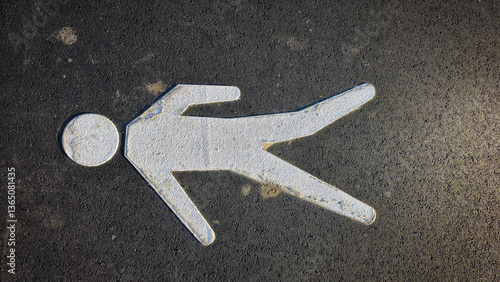 White stick figure on asphalt