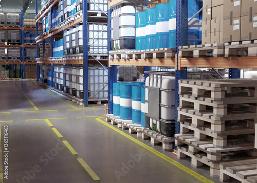 Foto Industrial warehouse with blue barrels, white containers, and cardboard boxes neatly stacked on racks along wide marked aisles