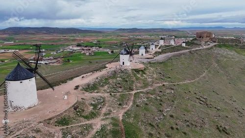 Drone video of Consuegra windmills and castle on hill