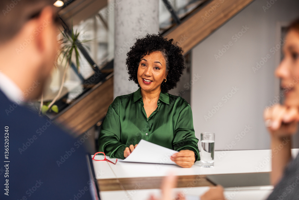 Professional Setting Conversation Featuring Confident Individuals in Office Environment