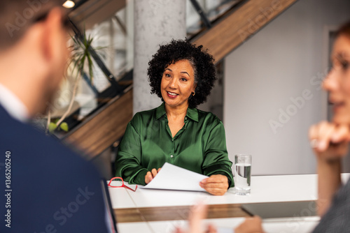 Obraz na płótnie Professional Setting Conversation Featuring Confident Individuals in Office Environment w salonie