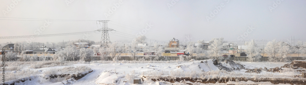 Obraz premium panorama of the city and power line with a view of the steppe in the morning in the fog 