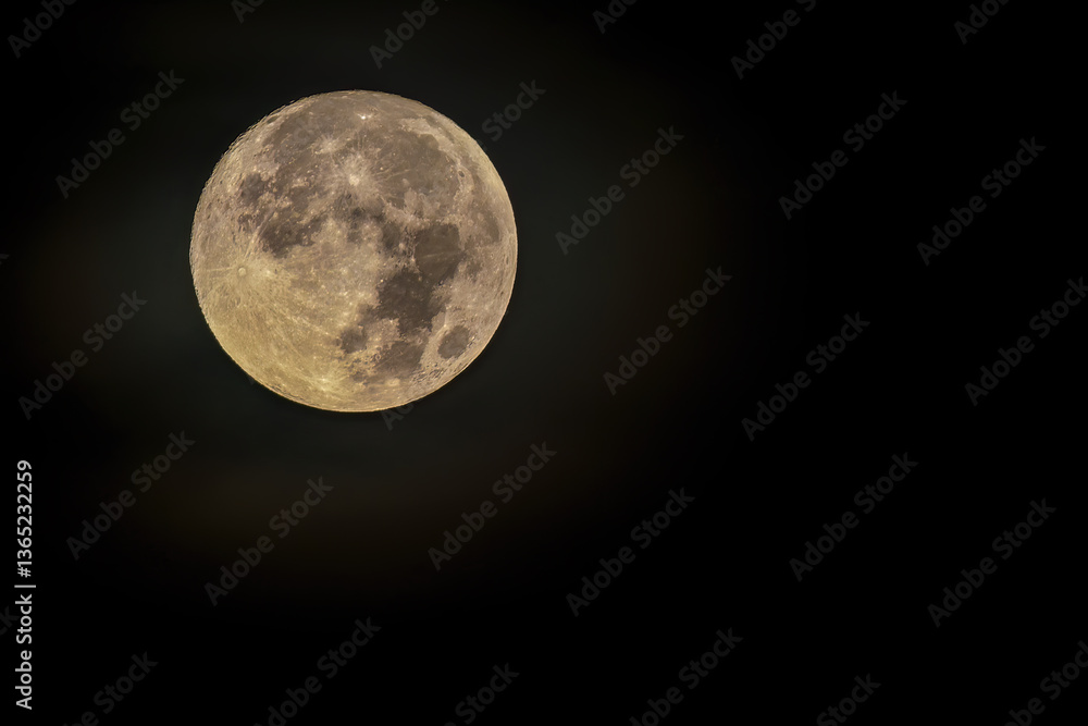 Obraz premium The full moon at west begins to be illuminated by the light of dawn, over the eastern Andean mountains of central Colombia.
