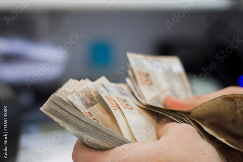 Businessman counting and exchanging money - Brazilian Real - Reais.