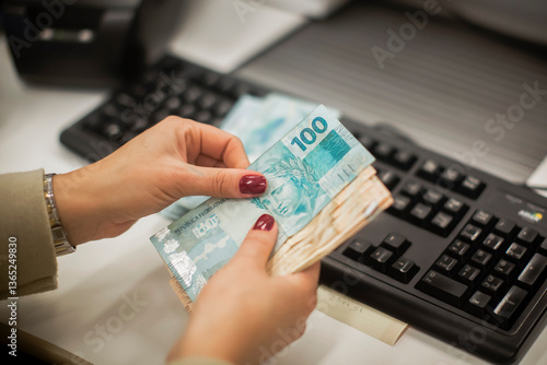 Businessman counting and exchanging money - Brazilian Real - Reais.