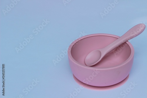 pink silicone bowl and spoon for kids isolated on white background