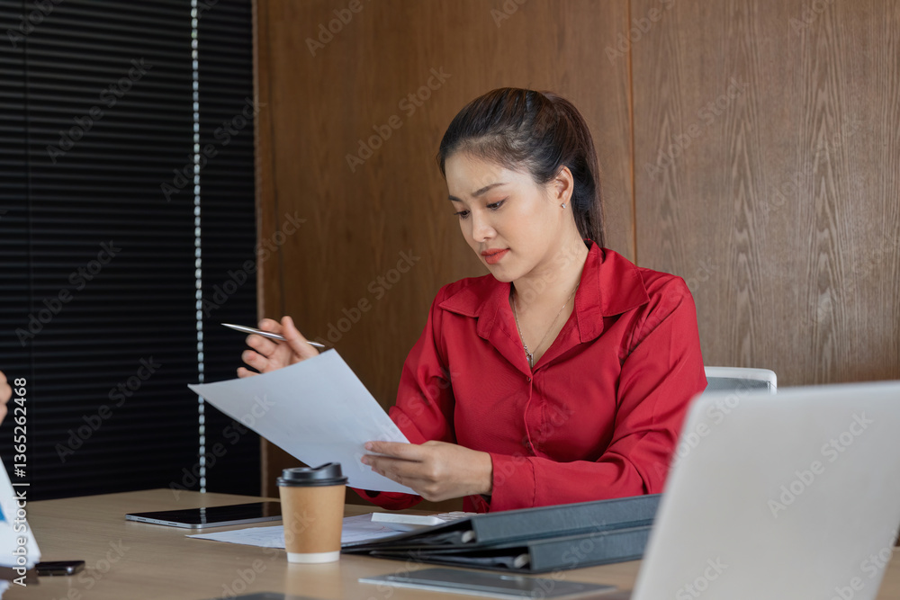 Analyzing Financial Reports. A dedicated professional reviews financial documents with a focused approach. Analyzing Financial Reports. A dedicated professional reviews financial documents with a focused approach.