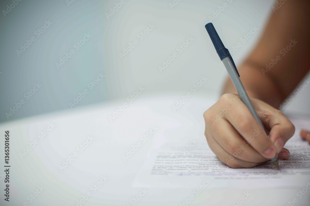 Crop shot of a business person with pen signing document Crop shot of a business person with pen signing document