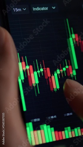 Close up of hands engaging with cryptocurrency data on a digital device. The analysis highlights market trends using colorful candlestick charts for research and informed trading decisions