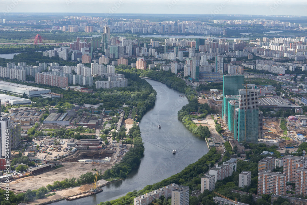 Fototapeta premium Aerial view of a vibrant city with a river flowing through it