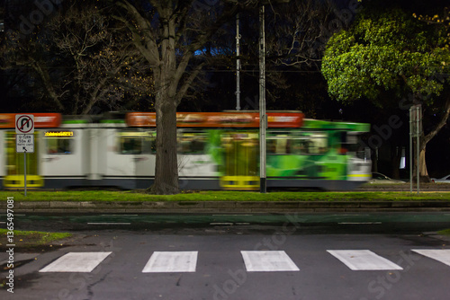 Moving tram and pedestrian crossing in a city