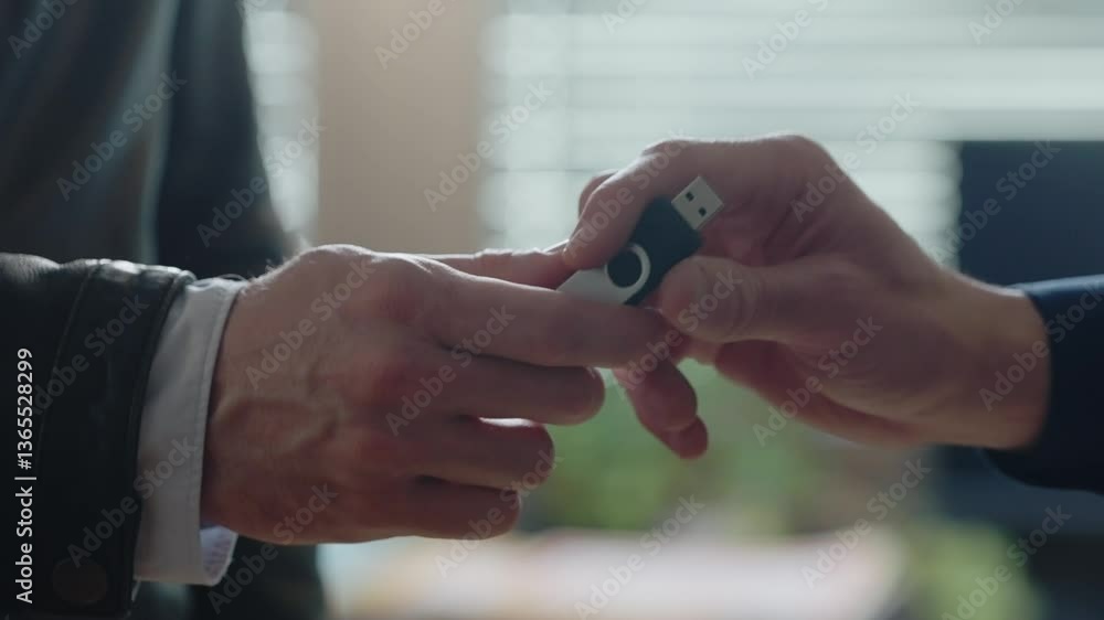 Handing a USB flash drive to another person, discreet data transfer, file sharing, or confidential exchange. Close-up. Technology, communication, security, and digital information Cybersecurity. Handing a USB flash drive to another person, discreet data transfer, file sharing, or confidential exchange. Close-up. Technology, communication, security, and digital information Cybersecurity.