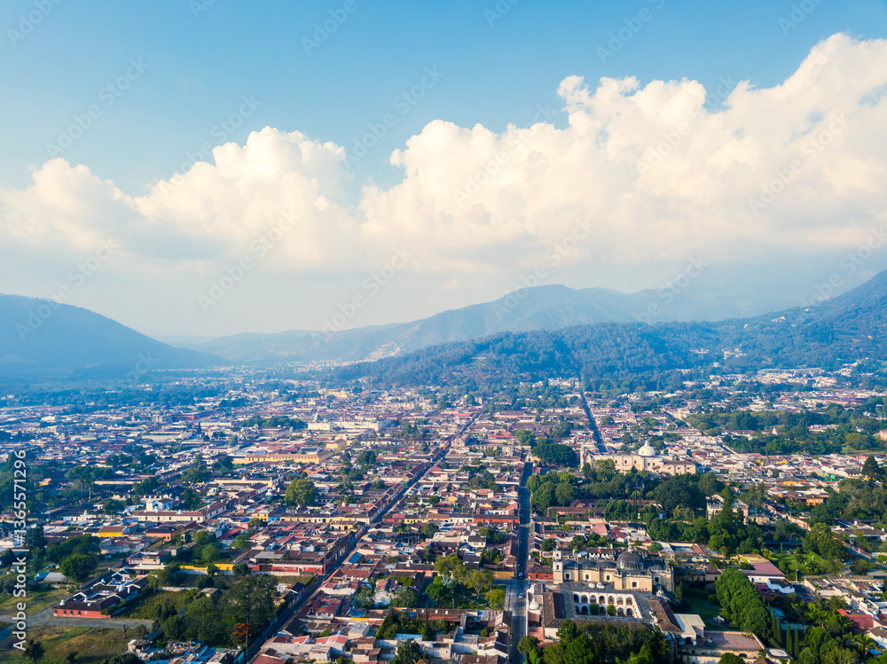 Obraz premium Panoramic view of the city of Antigua Guatemala, under a beautiful blue sky with clouds on the horizon.