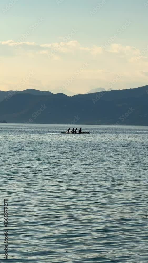 video of people excessing boat rowing water sport at Italian Garda lake at sunset video of people excessing boat rowing water sport at Italian Garda lake at sunset