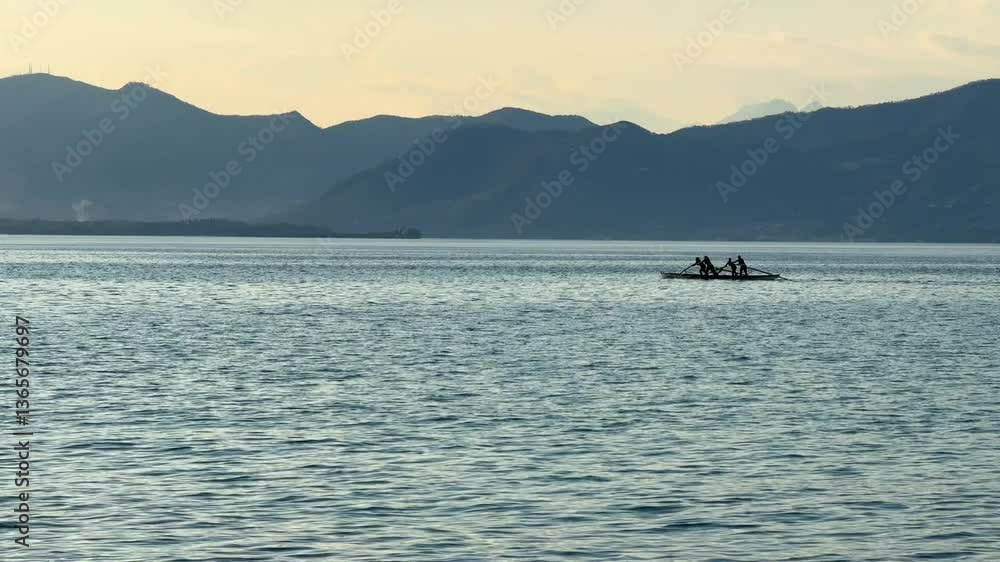 video of people excessing boat rowing water sport at Italian Garda lake at sunset video of people excessing boat rowing water sport at Italian Garda lake at sunset