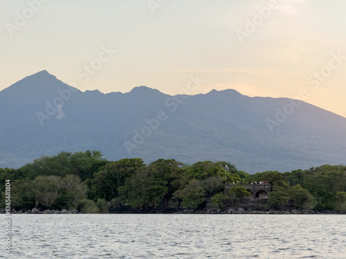 Ancient tower on volcano background