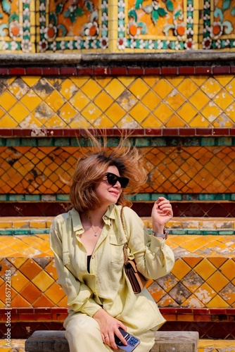 Photography Happy traveler enjoying the architectural beauty of Wat Pho, a historic Buddhist temple in Bangkok, Thailand