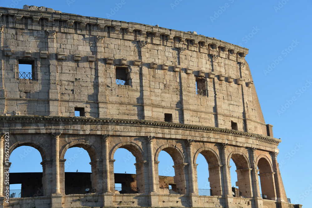 Obraz premium Called by the ancient Romans “Amphitheatrum Flavium”, the Colosseum is the most famous and impressive monument of Ancient Rome and the largest amphitheater in the world.