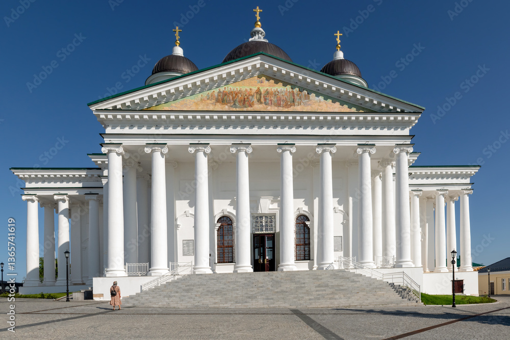 Obraz premium Majestic Cathedral of the Resurrection of Christ with domes against blue sky in Arzamas, surrounded by lush gardens and pathways, blending architectural beauty with tranquil urban landscaping
